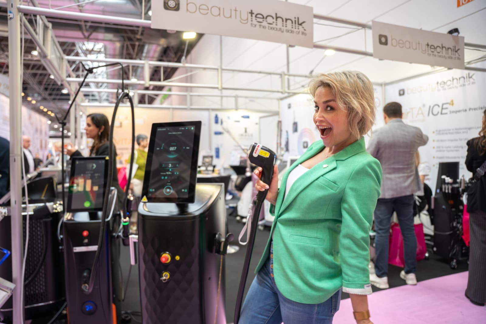 Kundin vor einem Beauty-Technik-Stand mit Lasergeräten.